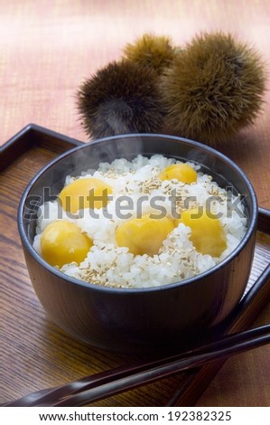 A bowl with rice and yellow food on a tray.