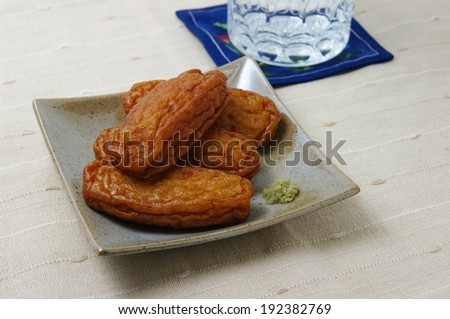 Four food patties set out on a square plate.