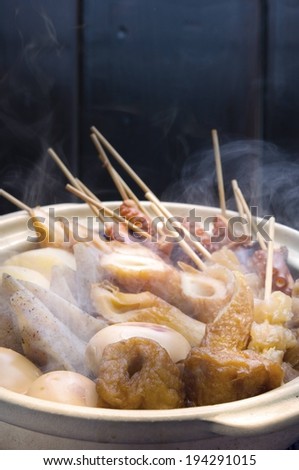 A dish of meat with skewers in them.