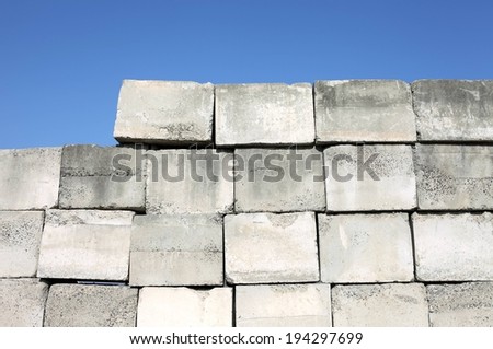 Various large concrete blocks stacked in the form of a wall.