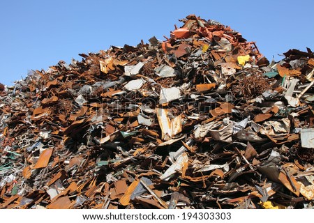 A big pile of junk and a clear blue sky.