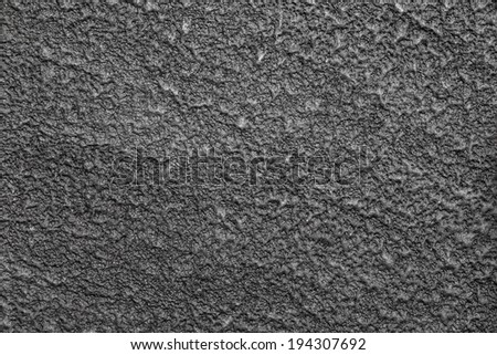 A dark gray surface that is evenly textured.