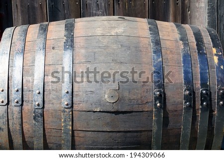 An aged wooden cask with rusted metal hoops.