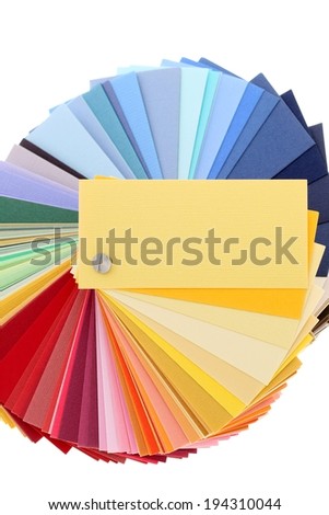 Many different colored swatches, held together, are fanned out.