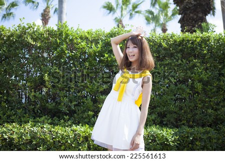Woman standing and holding a plastic bottle on a sunny summer day