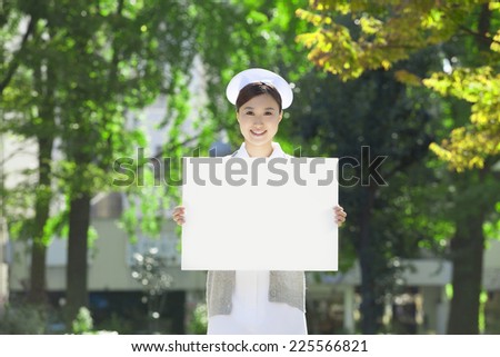 Nurses holding a white board
