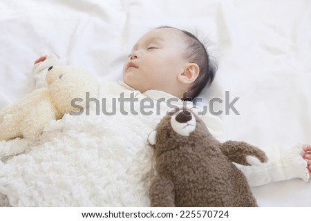 Baby sleeping with stuffed animals