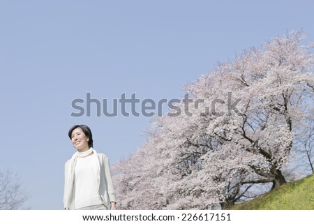 Oriental cherry tree rows and middle-aged woman