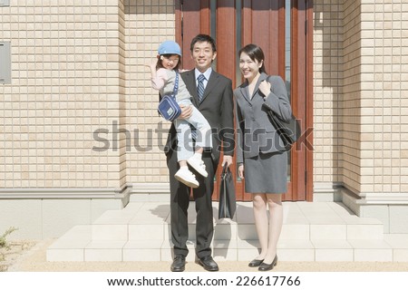 Family standing in front of the front door