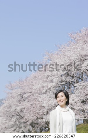 Oriental cherry tree rows and middle-aged woman
