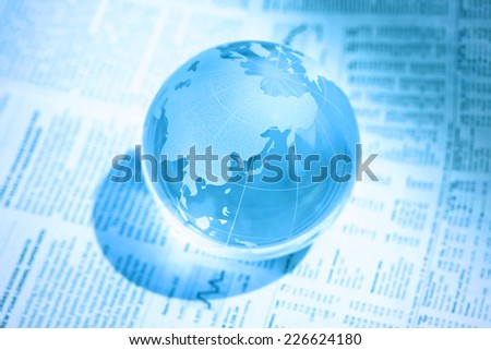 English-language newspaper and a glass globe