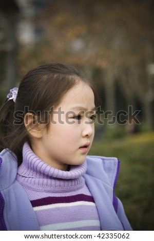 stock photo 8year old little asian girl in a city park shanghai