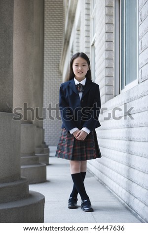 stock photo 9year old asian school girl in school uniform