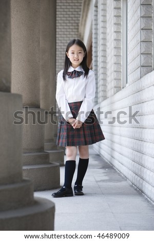 9-year old asian school girl in school uniform