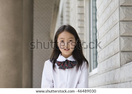 9-year old asian school girl in school uniform