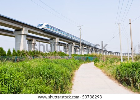 magnetic levitation (maglev) train travels at 431 km per hour through suburban shanghai, china