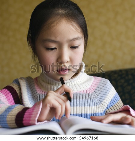 ten-year old asian schoolgirl studying