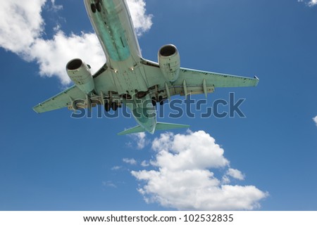 An airplane propelling past camera frame, making it able to capture a bottom shot of the vehicle in motion.