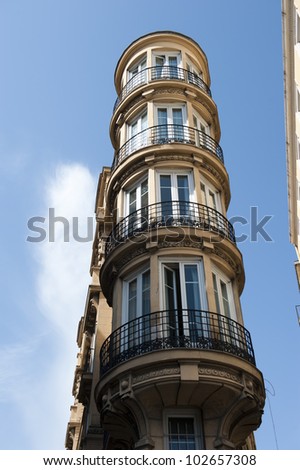 Artistic shot of a column design on the corner of a European building.