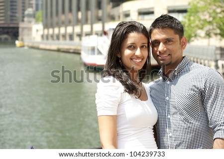 A young happy couple on a bridge.