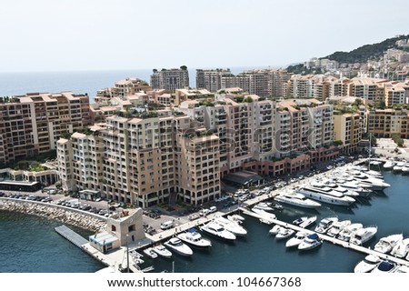 A beautiful, breath-taking birds eye view shot of the coastline of homes and yachts on the Mediterranean Sea in Monaco.