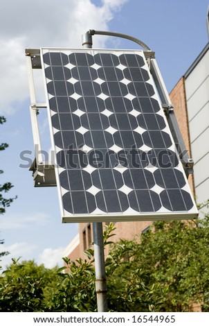 Photo of solar panel near trees on a sunny day.