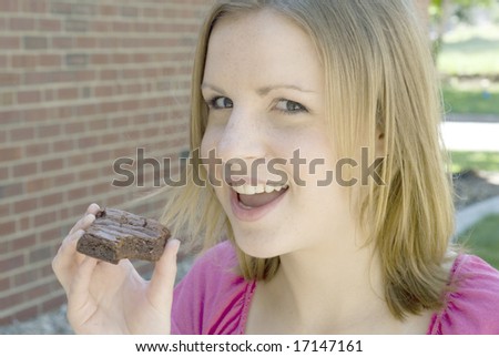 Girl smiling while holding a brownie