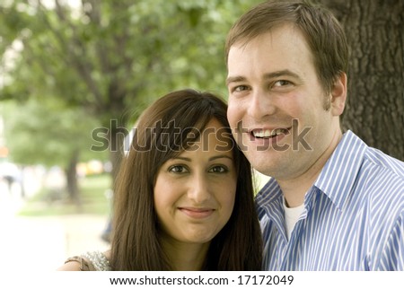 Close shot of man and woman laughing while photographed