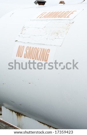 White propane tank with a no smoking sign on it