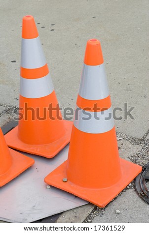 Set of orange and white traffic cones on the ground