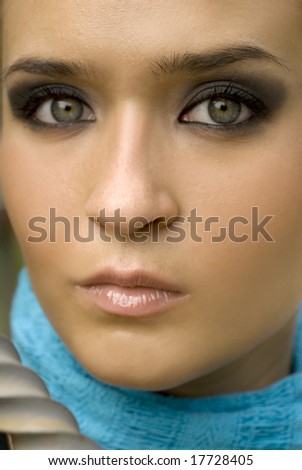 Olive skinned European beauty with green eyes with turquoise scarf