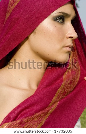 Beautiful woman with fuchsia head scarf on a sunny day