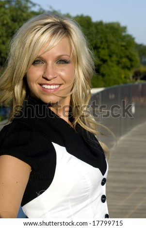 stock photo Shot of a pretty blonde model in a black shirt and white vest