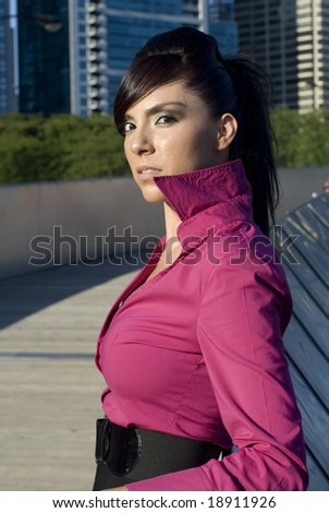 Photo of a dark-haired beauty with a pink collared shirt