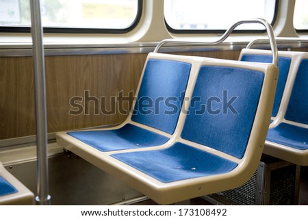 Two, bright, blue, sewn, bus seats made up of four squares.