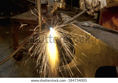 A metal fabricator utilizing a torch to heat up a piece of metal in order to shape it utilizing a forging technique developed over hundred years ago.