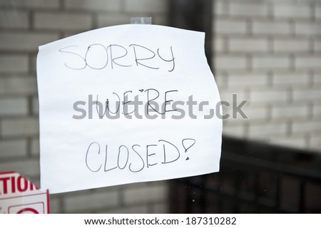 A sorry we\'re closed sign hanging at a food stop that was flooded.