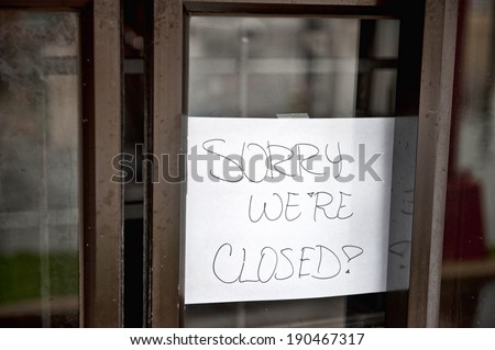 A sorry we're closed sign hanging at a food stop that was flooded.