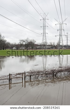 A set of power lines span the flood that engulfed the area with flood damage.