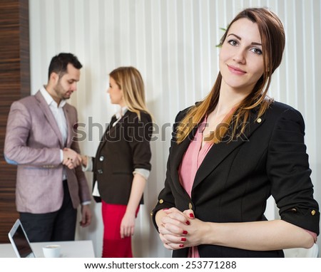 Image of businesswoman leader looking at camera in working environment.