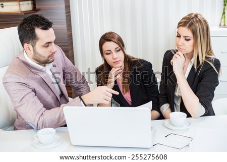 Business meeting, showing contract document, casual conversation at office, one man two beautiful females.