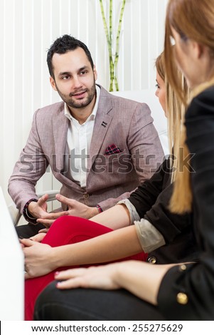 Business meeting, casual conversation at office, one man two beautiful females.