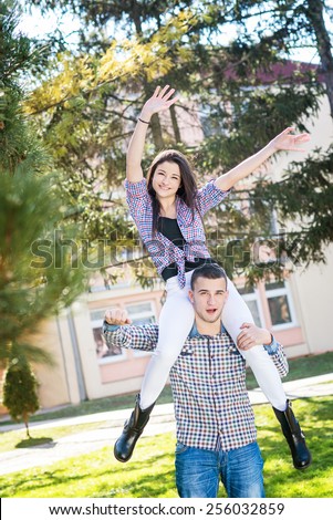 Two friends enjoying in summer day. Teenagers in park having fun.