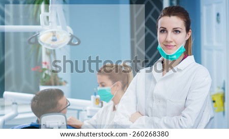 Portrait of beautiful female dentist at busy dentist office. Empty space for text sample.