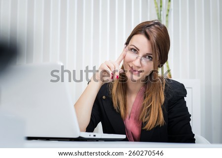 Portrait of beautiful business woman at office. Marketing manager. Internet developer.