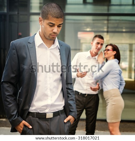 Gossip people in front of their office, handsome businessman portrait and racism gossip out of focus in background.