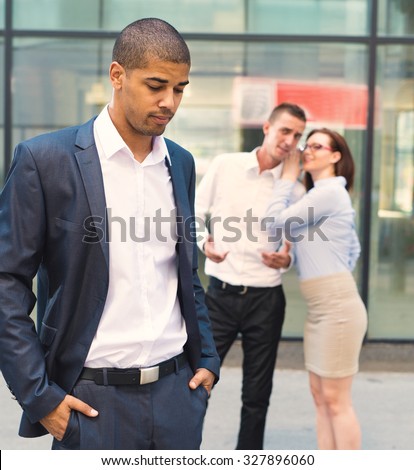 Gossip people in front of their office, handsome businessman portrait and racism gossip out of focus in background.