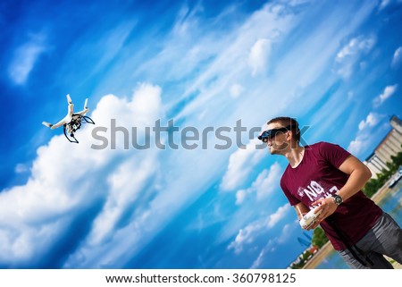 Man controling a drone.