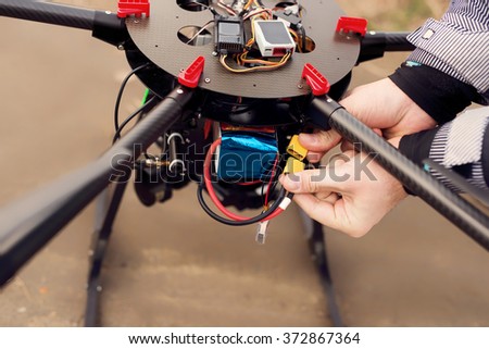 Connecting a battery on a drone.