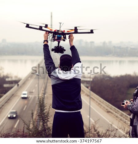 Man holding the drone, preparing for take off.